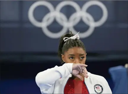 ?? ASHLEY LANDIS — THE ASSOCIATED PRESS ?? Simone Biles, of the United States, watches gymnasts perform after an apparent injury, at the 2020Summer Olympics, Tuesday, July 27, 2021, in Tokyo. Biles withdrew from the team finals.