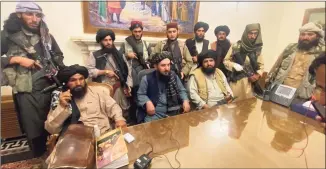  ?? Zabi Karimi / Associated Press ?? Taliban fighters take control of the Afghan presidenti­al palace on Sunday after President Ashraf Ghani fled the country.