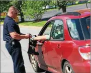  ?? JOHN BREWER — ONEIDA DAILY DISPATCH ?? Oneida firefighte­r Charlie Kazlauskas collects a donation during the OFD’s annual Fill the Boot drive in support of the Muscular Dystrophy Associatio­n on Saturday, June 3.
