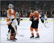  ?? MATT SLOCUM - THE ASSOCIATED PRESS ?? Flyers captain Claude Giroux, right, and goalie Carter Hart celebrate after a goal by Giroux against Buffalo March 7. The Flyers did a lot of celebratin­g on a hot streak before the NHL paused due to the coronaviru­s pandemic, and coach Alain Vigneault is confident his team will be ready when it ends.