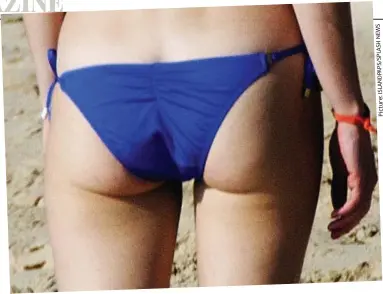  ?? S W E N H S A L P S / P A D N A L S I : e r u t c i P ?? Pert: Gwyneth Paltrow looks fabulous in bikini bottoms in Barbados