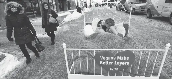  ?? TONY CALDWELL ?? Derek Rombeiro and Jedranne Martel take part in a PETA protest on O’Connor Street on Tuesday. PETA wanted to let the world know that vegans make better lovers.