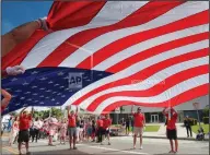  ?? Richard Vogel/AP ?? Parade: Participan­ts carry an American flag during the 4th of July parade in Santa Monica, Calif. on Tuesday.