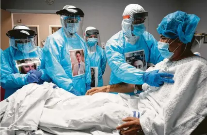  ?? Godofredo A. Vásquez / Staff photograph­er ?? Juan Carlos Peña, 43, is checked on by physicians and nurses before they administer an ultrasound on his lungs at United Memorial Medical Center. Peña went to the hospital after spending a week with a fever, body ache and nonstop coughing.