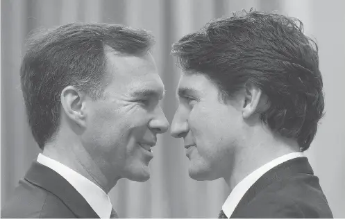  ?? SEAN KILPATRICK / THE CANADIAN PRESS ?? Finance Minister Bill Morneau , left, and Prime Minister Justin Trudeau have their eyes on hiking tax rates for high-income earners.