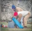  ??  ?? Jason and Ilene Ford of Liberty, Miss, try to salvage some tools that had been in storage building behind their home after a tornado on Monday hit in Amite County, in Liberty, Miss on Dec 17. The building was taken off its slab and ended up on the other side of the yard. (AP)