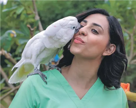  ?? Victor Besa / The National ?? Businesswo­man and animal welfare activist Afra Al Dhaheri with one of the many creatures at Cloud 9