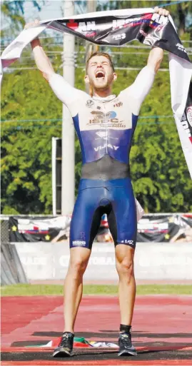  ?? (Mark Balmores) ?? NICK Baldwin of Seychelles celebrates his victory in the 2018 Century Tuna Ironman Philippine­s yesterday in Subic Bay.