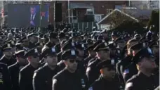  ?? JOHN MINCHILLO/THE ASSOCIATED PRESS ?? New York City police officers turn their backs as Mayor Bill de Blasio speaks at the funeral of police officer Rafael Ramos on Saturday.