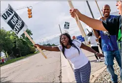  ?? Associated Press ?? ■ Flint resident Dorrit Madison shouts out at cars passing by as General Motors employees demonstrat­e Sunday outside of the Flint Assembly Plant in Flint, Michigan. GM autoworker­s were set to officially go on strike just before midnight Sunday after UAW leadership voted to do so Sunday morning.