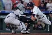  ?? KEVIN M. COX - THE ASSOCIATED PRESS ?? Houston Astros’ Mauricio Dubon is tagged out at the plate by New York Yankees catcher Jose Trevino during the ninth inning to preserve a 5-4victory.