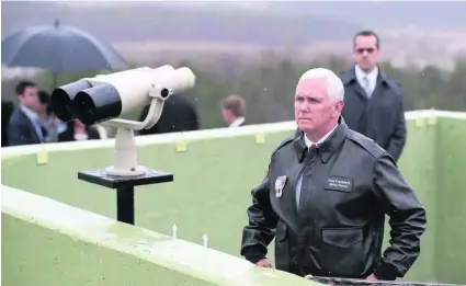  ?? Lee Jin-man / AP Photo ?? US vice president Mike Pence looks over North Korea from the demilitari­sed zone dividing the countries yesterday.