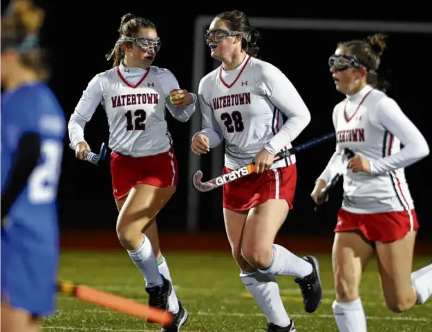  ?? JIM DAVIS/GLOBE STAFF ?? Molly Driscoll (12) and Caroline Andrade (28) celebrated the first goal of a 6-0 Division 3 semifinal win over Dover-Sherborn in a 22-0 season.