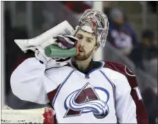  ?? THE ASSOCIATED PRESS ?? Colorado Avalanche goalie Jeremy Smith drinks from a bottle between plays against the Devils during the second period of a game on Tuesday night at the Prudential Center in Newark.