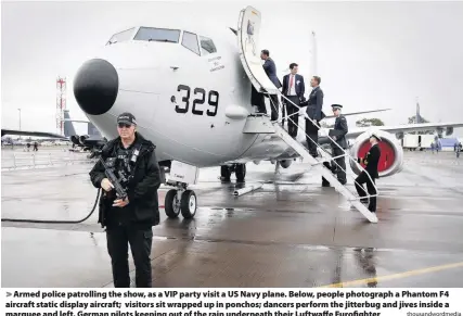  ?? Thousandwo­rdmedia ?? Armed police patrolling the show, as a VIP party visit a US Navy plane. Below, people photograph a Phantom F4 aircraft static display aircraft; visitors sit wrapped up in ponchos; dancers perform the jitterbug and jives inside a marquee and left, German pilots keeping out of the rain underneath their Luftwaffe Eurofighte­r