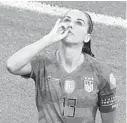  ?? JEAN-PHILIPPE KSIAZEK/AFP-GETTY ?? Alex Morgan, left, celebrates with an imaginary sip of tea after scoring a goal during a 2-1 win over England on Tuesday.