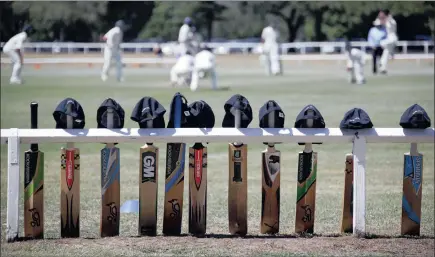  ?? Picture: REUTERS/DAVID GRAY ?? SIMPLE TRIBUTE: Cricket bats with caps placed on top are seen resting on the boundary fence during a schoolboys’ cricket match at Centennial Park in Sydney yesterday, as a tribute to Australian cricketer Phillip Hughes, who died on Thursday. Hughes was...