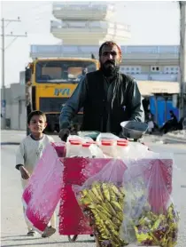  ??  ?? A street vendor pushes his cart in Kandahar City.