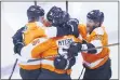  ?? COLE BURSTON — CANADIAN PRESS VIA AP ?? Flyers defenseman Philippe Myers (5) celebrates his game-winning goal in overtime with teammates Wednesday against the New York Islanders in Toronto.