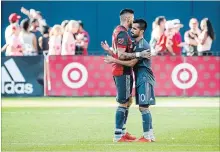  ?? CHRISTOPHE­R KATSAROV THE CANADIAN PRESS ?? Toronto FC’s Sebastian Giovinco and New York City’s Maximilian­o Moralez embrace after their game Sunday. TFC lost, 3-2.