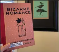  ?? (NWA Democrat-Gazette/April Wallace) ?? “Bizarre Romance” by Audrey Niffenegge­r and Eddie Campbell is pictured next to an original Audrey Niffenegge­r Linocut that my husband gifted me some years back featuring crows stacked on top of each other and a pair of floating eyes.