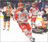  ?? Steve McLaughlin / Sacred Heart University ?? Sacred Heart’s Alex Bates celebrates during the Pioneers’ 9-4 win over RIT in the Atlantic Hockey quarterfin­als at Webster Bank Arena Wednesday in Bridgeport.