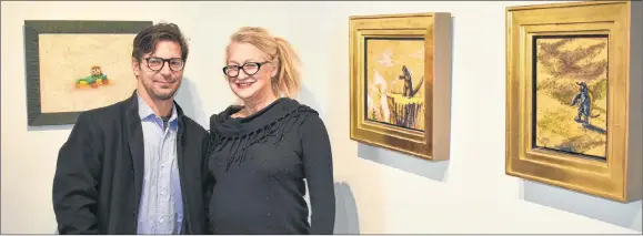  ?? ADAM MACINNIS/THE NEWS ?? Studio Lab Gallery owner Ken Roux and artist Joan Krawczyk stand near some of her gold leaf Godzilla paintings.