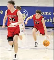  ?? Photograph­s by Samantha Huffman ?? Blackhawk senior Greydon Edwards, No. 21, drives toward the goal in the game against the Harrison Goblins Friday, Jan. 29, with junior Jared Brewer, No. 20, ahead of him.