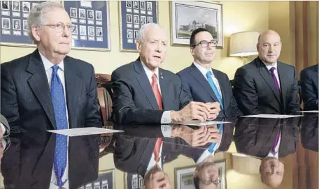  ?? J. Scott Applewhite Associated Press ?? SENATE Majority Leader Mitch McConnell, left, Senate Finance Committee Chairman Orrin Hatch, Treasury Secretary Steven Mnuchin and National Economic Council Director Gary Cohn address reporters on the Republican tax bill in Washington.