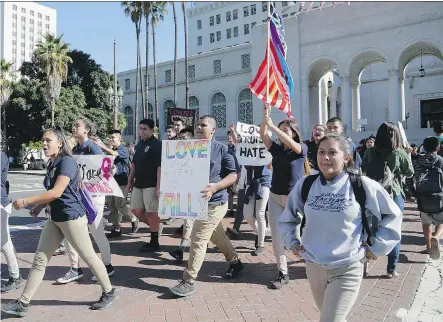  ?? NICK UT/ THE ASSOCIATED PRESS ?? Students took to the streets outside Los Angeles city hall to protest against President Donald Trump, whose conflictin­g messages on religious freedoms and protection­s for the LGBT community are the source of worry for both sides