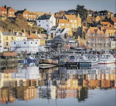  ?? PICTURE: MARISA CAHILL ?? BENEFIT: Whitby, seen here at sunset, and Scarboroug­h were awarded a total of £37m from the fund.