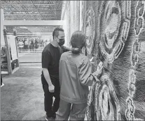  ?? ?? People visit a Tibetan carpet company in Xining, Qinghai.