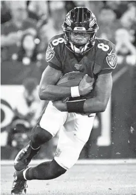  ?? KENNETH K. LAM/BALTIMORE SUN ?? Ravens’ Lamar Jackson runs against the Tennessee Titans in the first quarter Saturday.