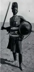  ??  ?? Left: An Eritrean Sciumbasci (Sergeant-Major) of the 19th Mixed Battalion, photograph­ed in Tripolitan­ia during 1925.
This photo was surely made for a special occasion, since the three weapons carried by this veteran are clearly unorthodox