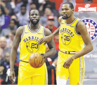  ?? David J. Phillip / Associated Press ?? The Warriors’ Kevin Durant (35) looks away as he pats Draymond Green on the chest after a Green turnover during the second half.