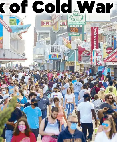  ??  ?? With the easing of coronaviru­s restrictio­ns, visitors crowd the boardwalk on Memorial Day weekend in Ocean City, Maryland on Saturday.