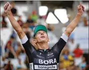  ?? CHRISTOPHE ENA / ASSOCIATED PRESS ?? Stage winner Maciej Bodnar of Poland celebrates on the podium after he won the 20th stage Saturday, a time trial covering 14 miles.