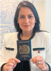  ?? HOME OFFICE ?? Feeling blue: Home Secretary Priti Patel displays the new blue passport UK citizens will use after Brexit