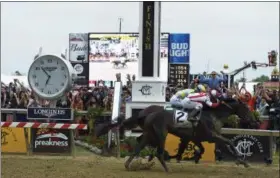  ?? MIKE STEWART — THE ASSOCIATED PRESS ?? Cloud Computing (2), ridden by Javier Castellano, wins the Preakness Stakes at Pimlico race course as Classic Empire with Julien Leparoux aboard takes second on May 20.
