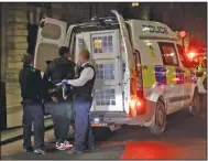  ?? (AP/Matt Dunham) ?? British police remove people who had gathered late Thursday opposite the London Eye Ferris wheel by the River Thames in London, where traditiona­lly fireworks usher in the new year. The fireworks were canceled this year because of the pandemic.