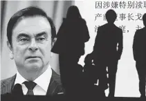  ?? EPA-Yonhap ?? Pedestrian­s watch large-scale screen displaying a news program reporting on former Nissan Motor chairman Carlos Ghosn attending a court hearing at Tokyo district court, in Tokyo, Jan.8.