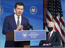  ?? KEVIN LAMARQUE — POOL VIA AP ?? Former South Bend, Ind. Mayor Pete Buttigieg, Presidente­lect Joe Biden’s nominee to be transporta­tion secretary, reacts to his nomination as Biden looks on during a news conference at The Queen theater in Wilmington, Del., Wednesday, Dec. 16, 2020.