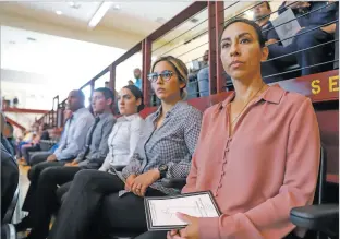  ?? GABRIELA CAMPOS THE NEW MEXICAN ?? ABOVE: From right, SFPD pre-academy cadets Loretta Easterling, Sarah Priemazon, Dominique Romero, Carlos Camacho, Donald Lindsey and Alan Scott watch from the bleachers at Santa Fe Indian School last week as the New Mexico Law Enforcemen­t Academy graduates and swears in 45 officers.