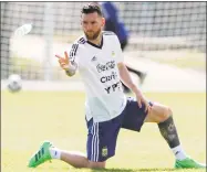  ?? Ricardo Mazalan / Associated Press ?? Lionel Messi throws a bottle of water during a training session in Bronnitsy, Russia, on Friday.