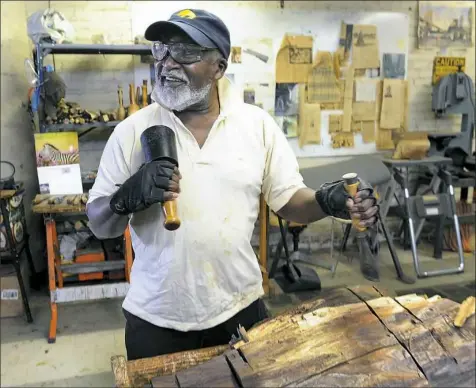  ?? Nate Guidry/Post-Gazette photos ?? Thaddeus Mosley at work in his studio in Manchester this past April. At left, a sculpture titled “Cloud,” carved from walnut and cherry wood, was installed recently at the Westmorela­nd Museum of American Art.