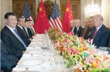  ?? — AFP ?? US President Donald Trump (R) and China’s President Xi Jinping (L) along with members of their delegation­s, have dinner at the end of the G20 Leaders’ Summit in Buenos Aires, Argentina.