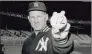  ?? Associated Press ?? Warming up for his starting role in the opening game of the 1964 World Series, Whitey Ford uses a ball that signifies it will be the 12th series he has been in. The Hall of Famer died Friday at 91.