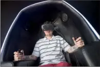  ?? NWA Democrat-Gazette/J.T. WAMPLER ?? Dustin McVay of Seligman, Mo., rides a virtual roller coaster at Virtual Game World & Event Center in Rogers. The virtual reality industry is expected to grow from $90 million in 2014 to $5.2 billion in 2018.