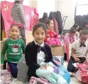  ?? | MARK BROWN/ SUN- TIMES ?? Students at Octavio Paz elementary open their gifts provided through the Chicago Sun- Times’ Letters to Santa program.