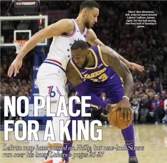  ?? CHRIS SZAGOLA — THE ASSOCIATED PRESS ?? 76ers’ Ben Simmons, left, tries to reach around Lakers’ LeBron James, right, for the ball during the first half of Sunday’s game.